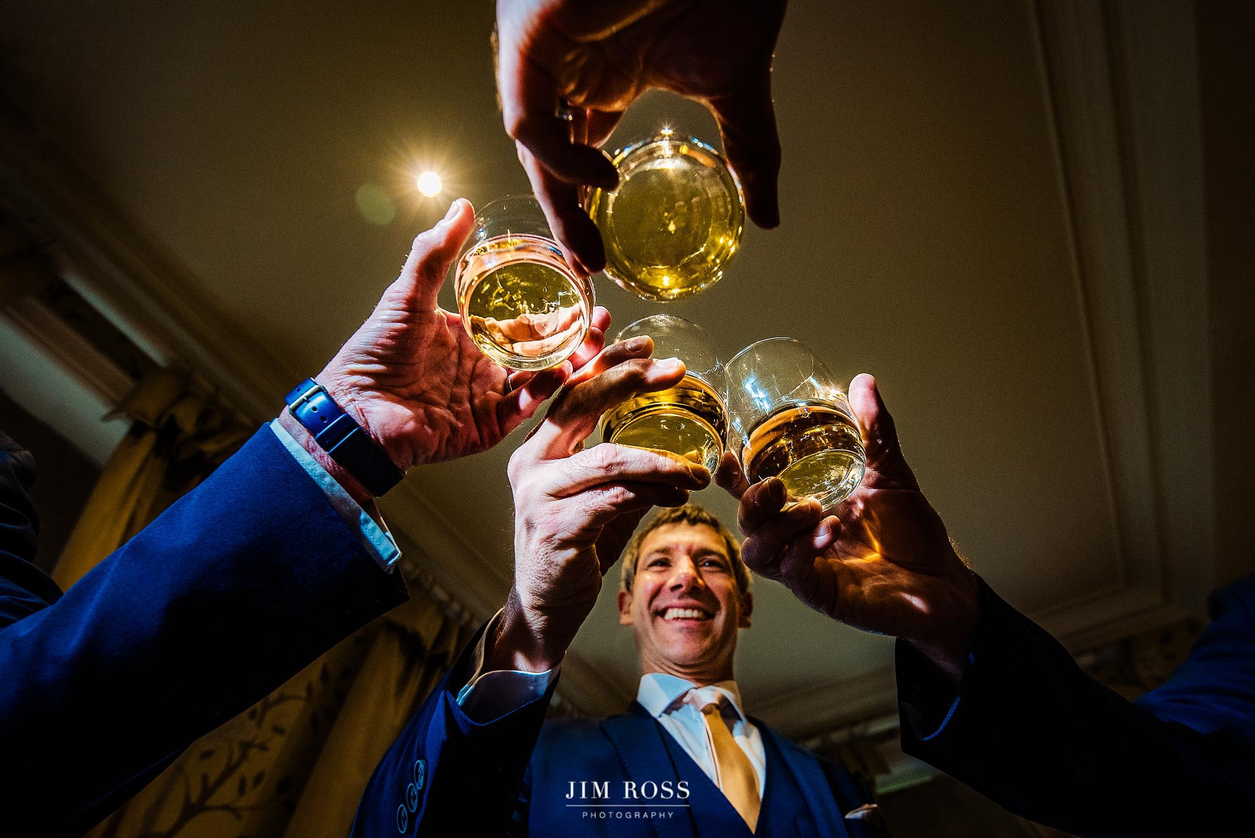 groomsmen cheers with whisky