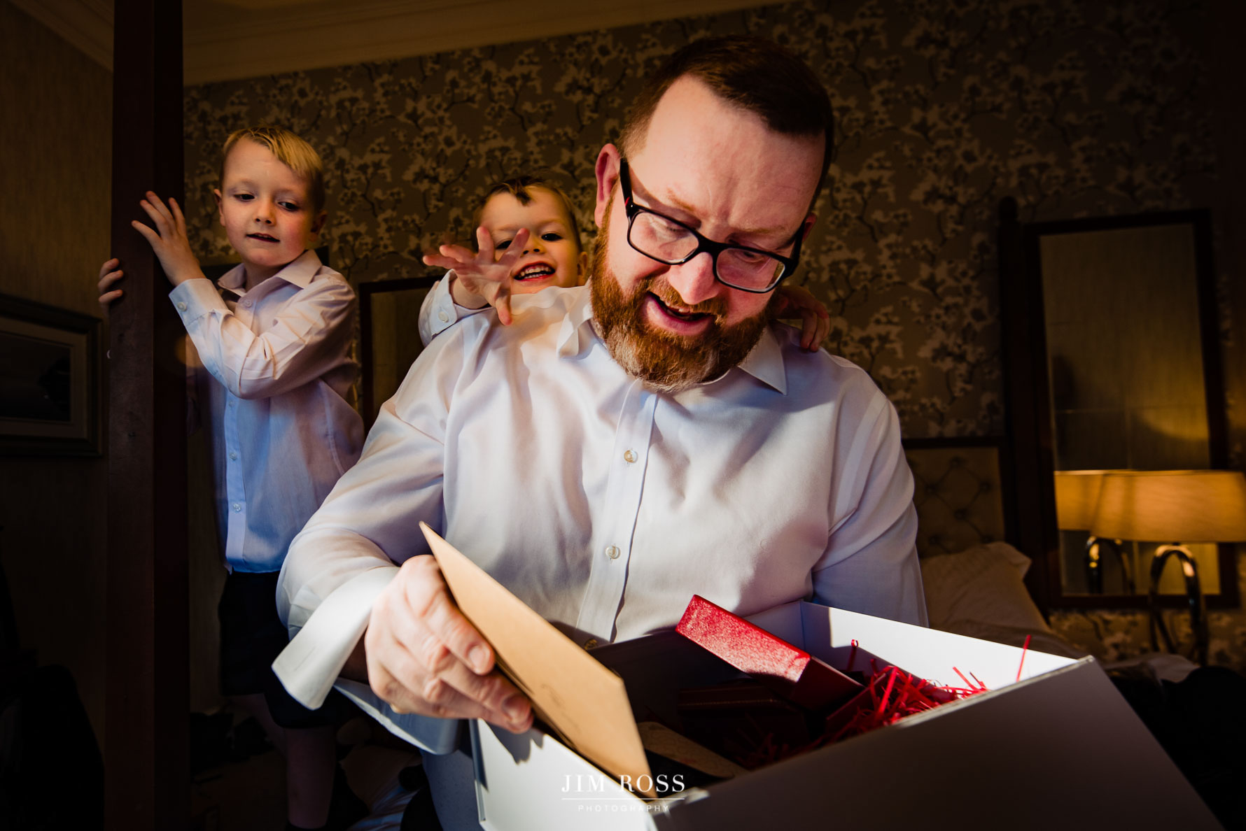 gift from bride to groom with excited boys looking on