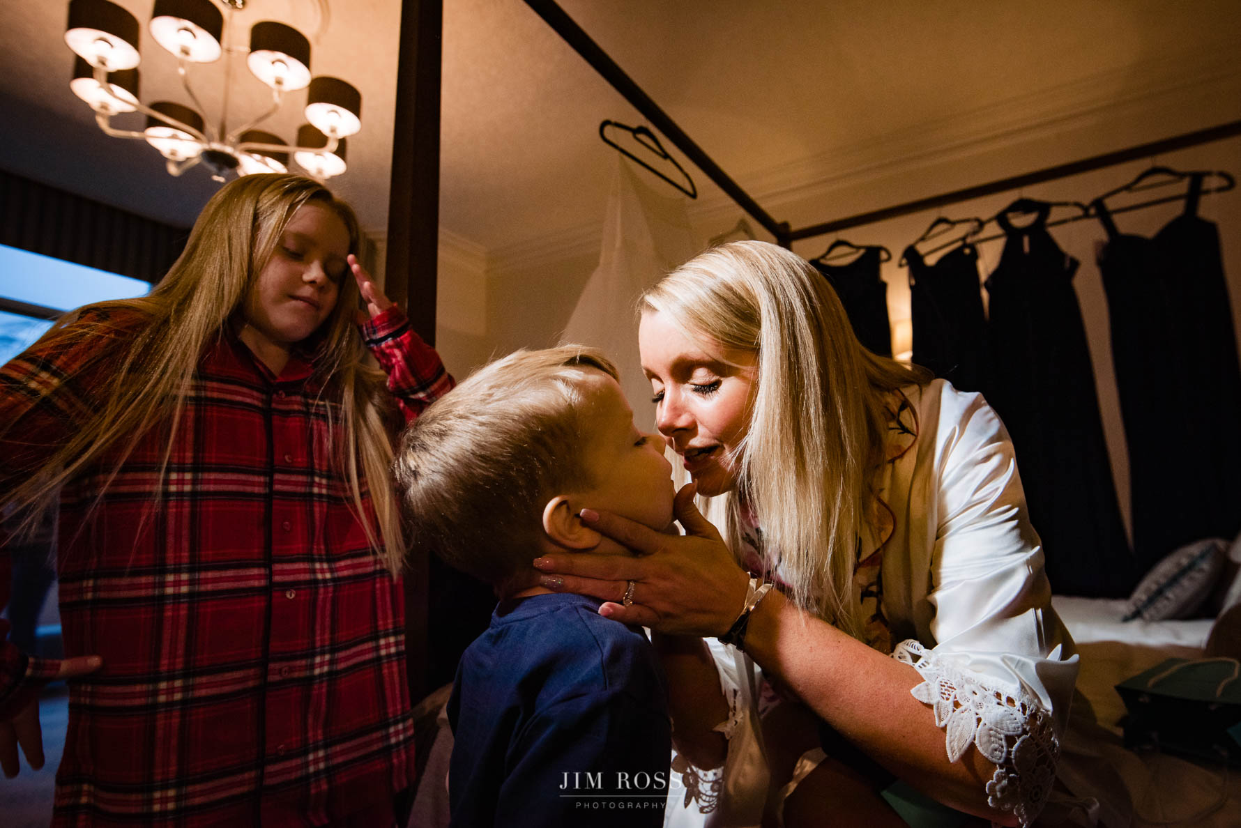 bride kisses son as he delivers gift from groom