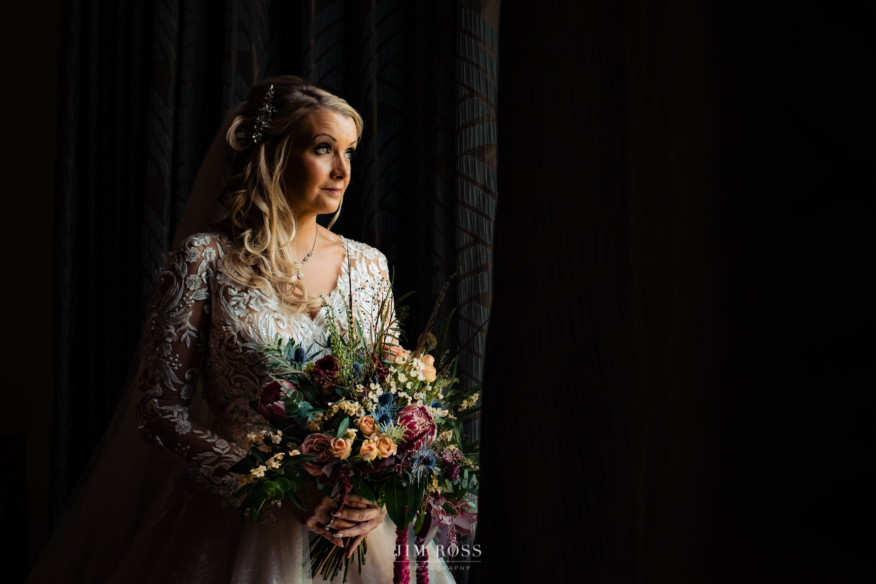 window portrait for bride with flowers