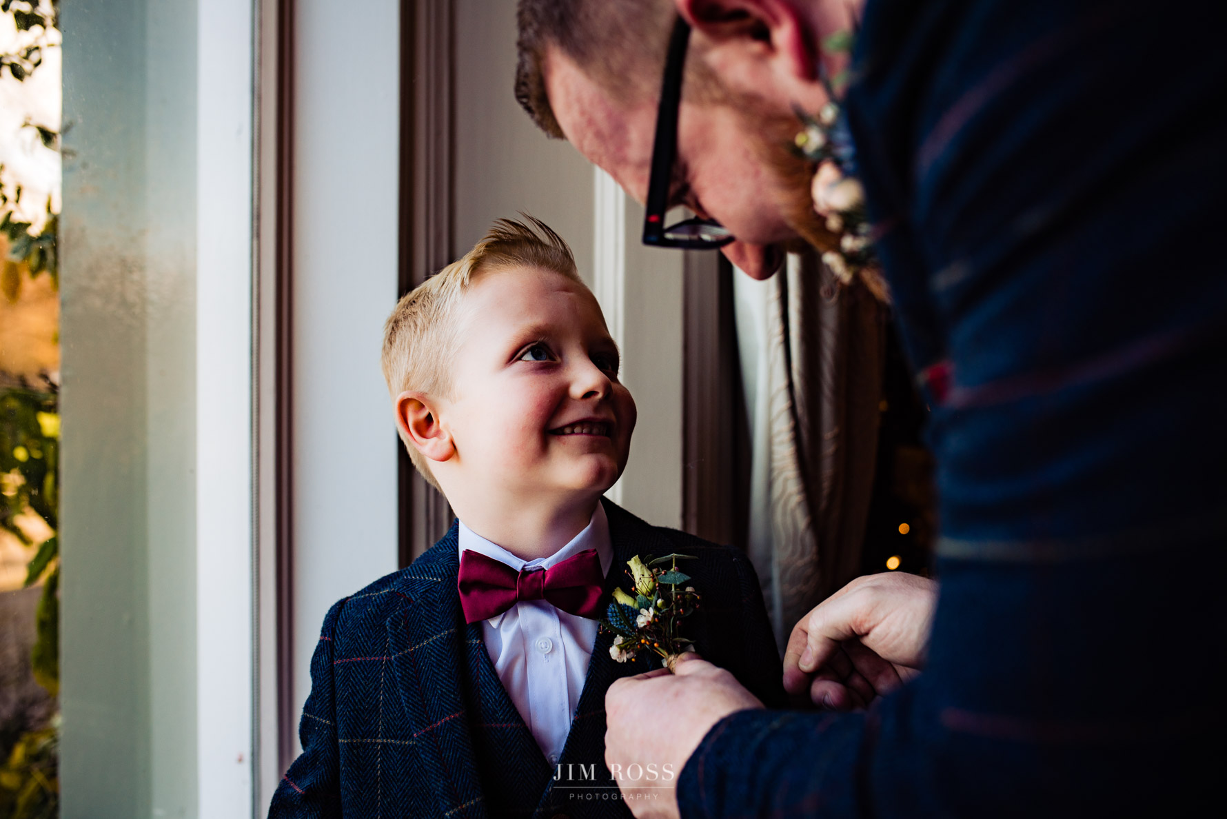 groom sorts son's button hole