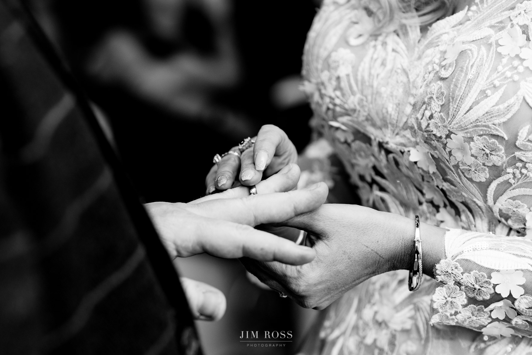 bride puts ring on grooms finger