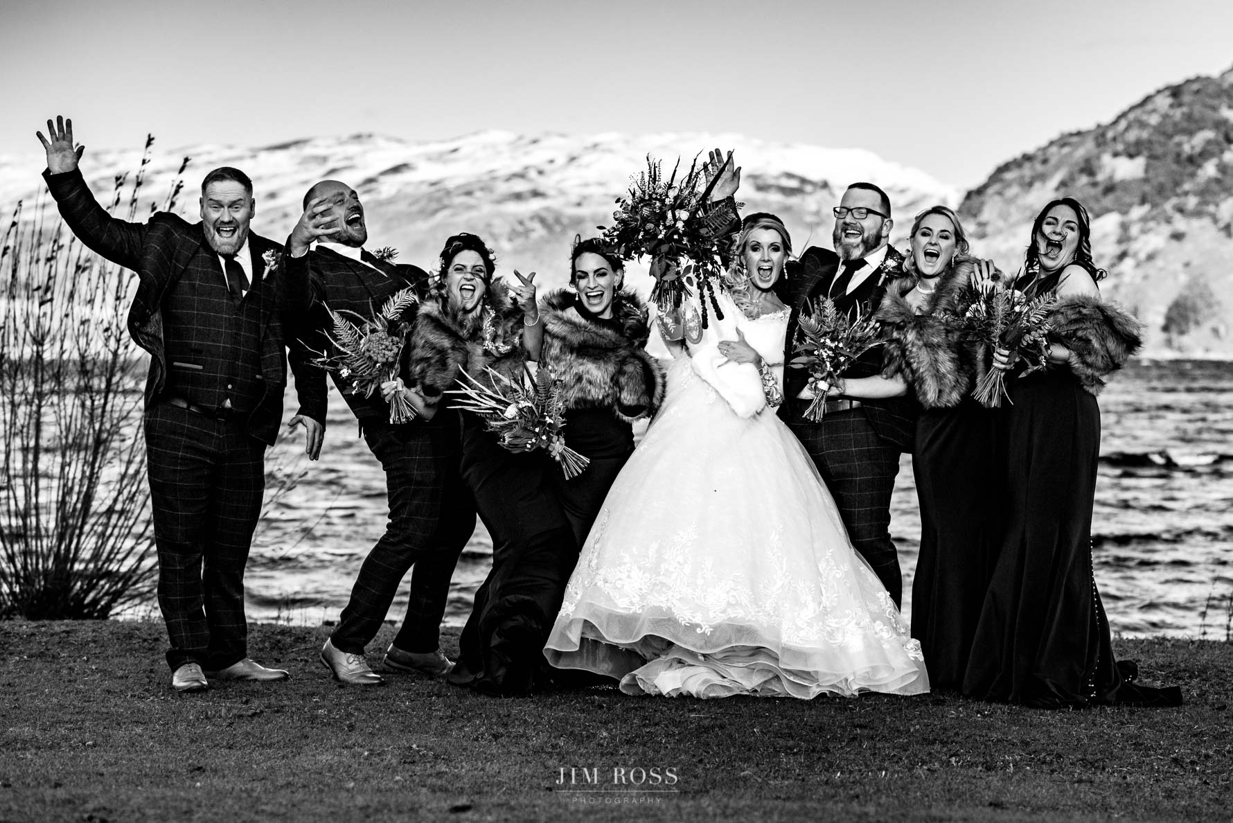 fun bridal party group shot with snowy mountains behind