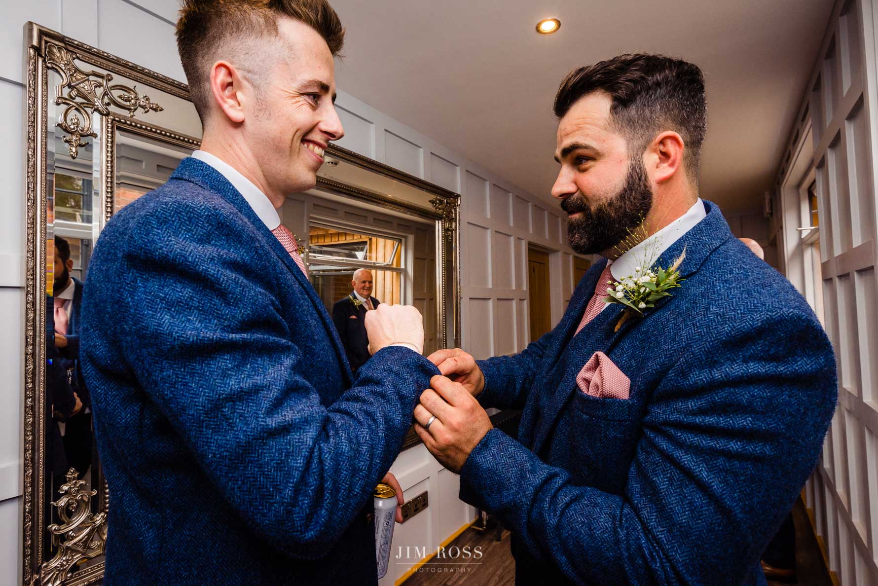 groom gets help with cufflinks
