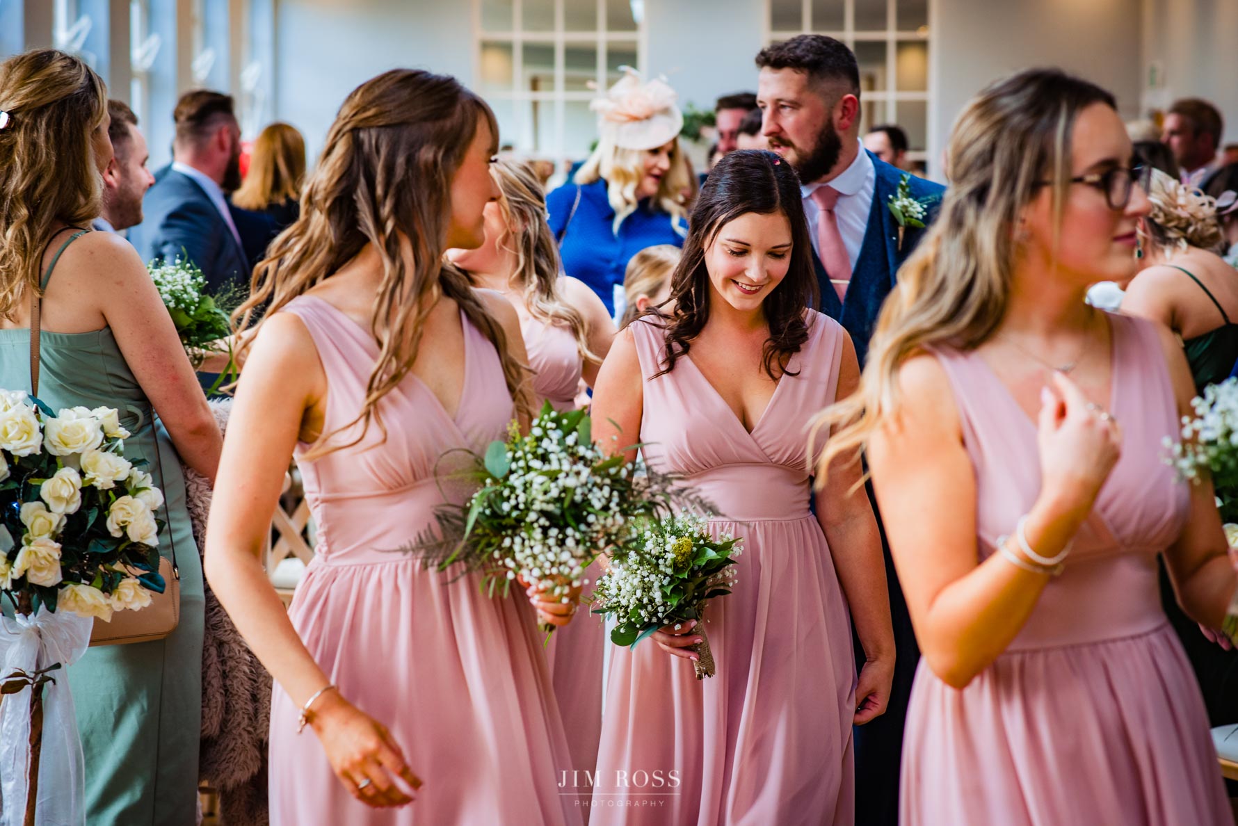 bridesmaids file out of bredenbury court wedding ceremony