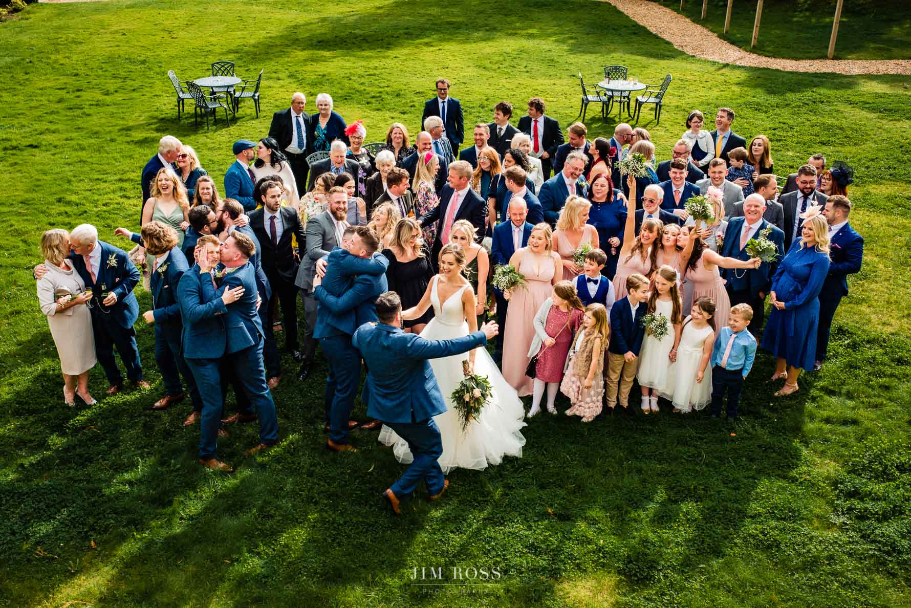 daft moment for entire wedding party on the lawn