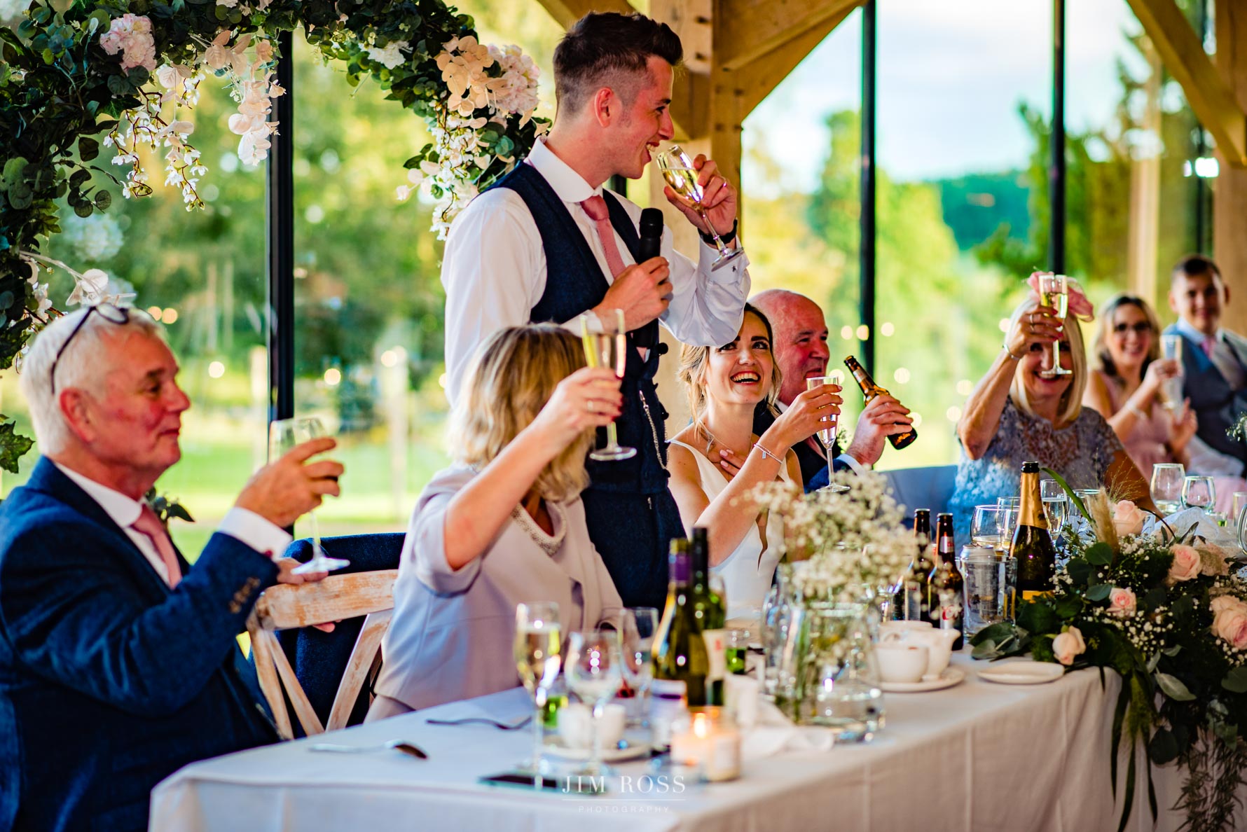 groom raises a glass during speech