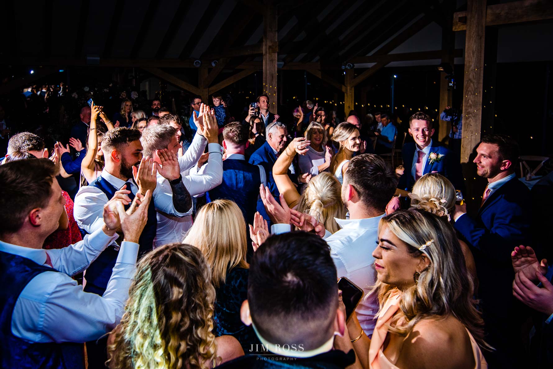 bride and groom can't excited faces at crowded dance floor fun