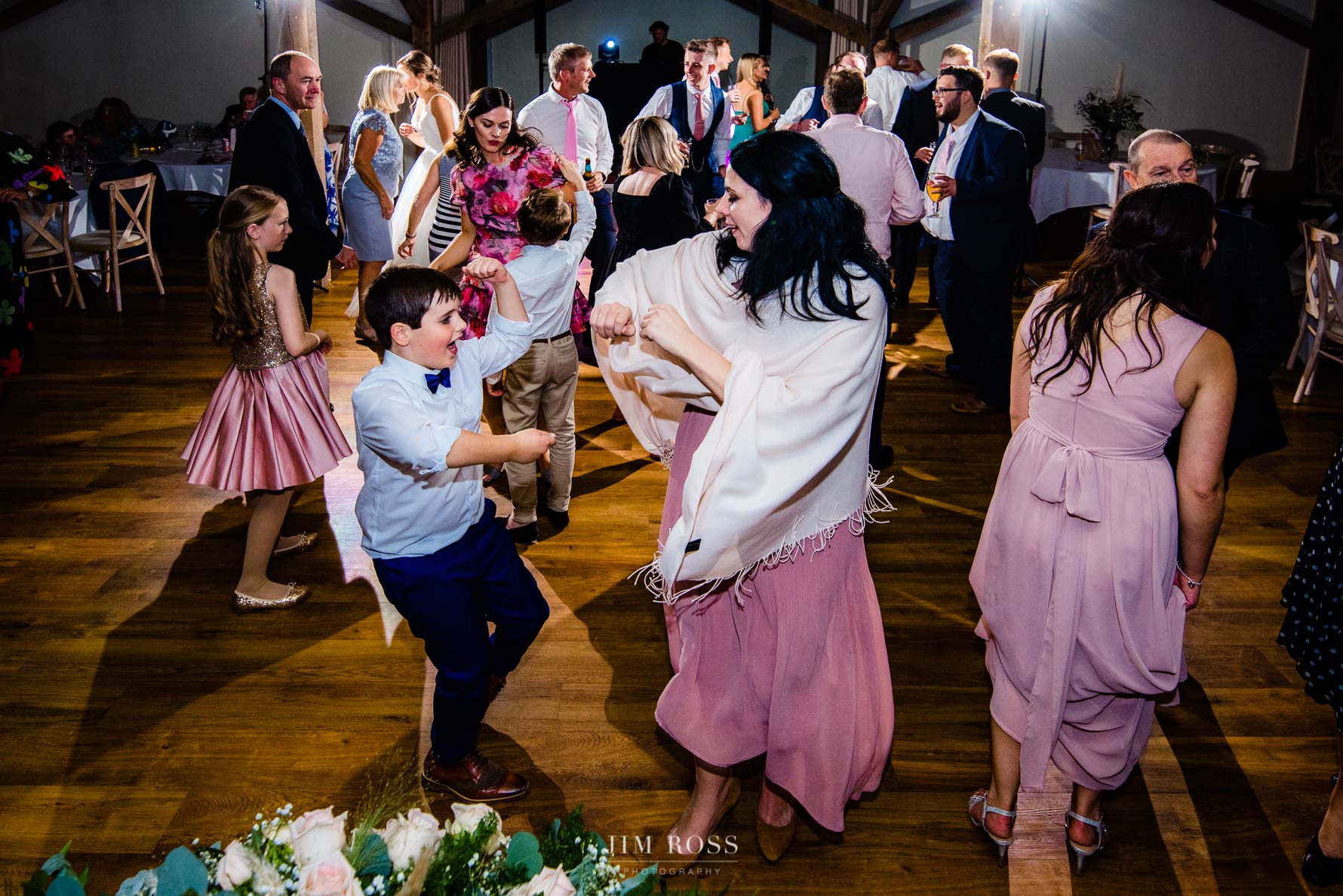 young lad dancing with mum at wedding