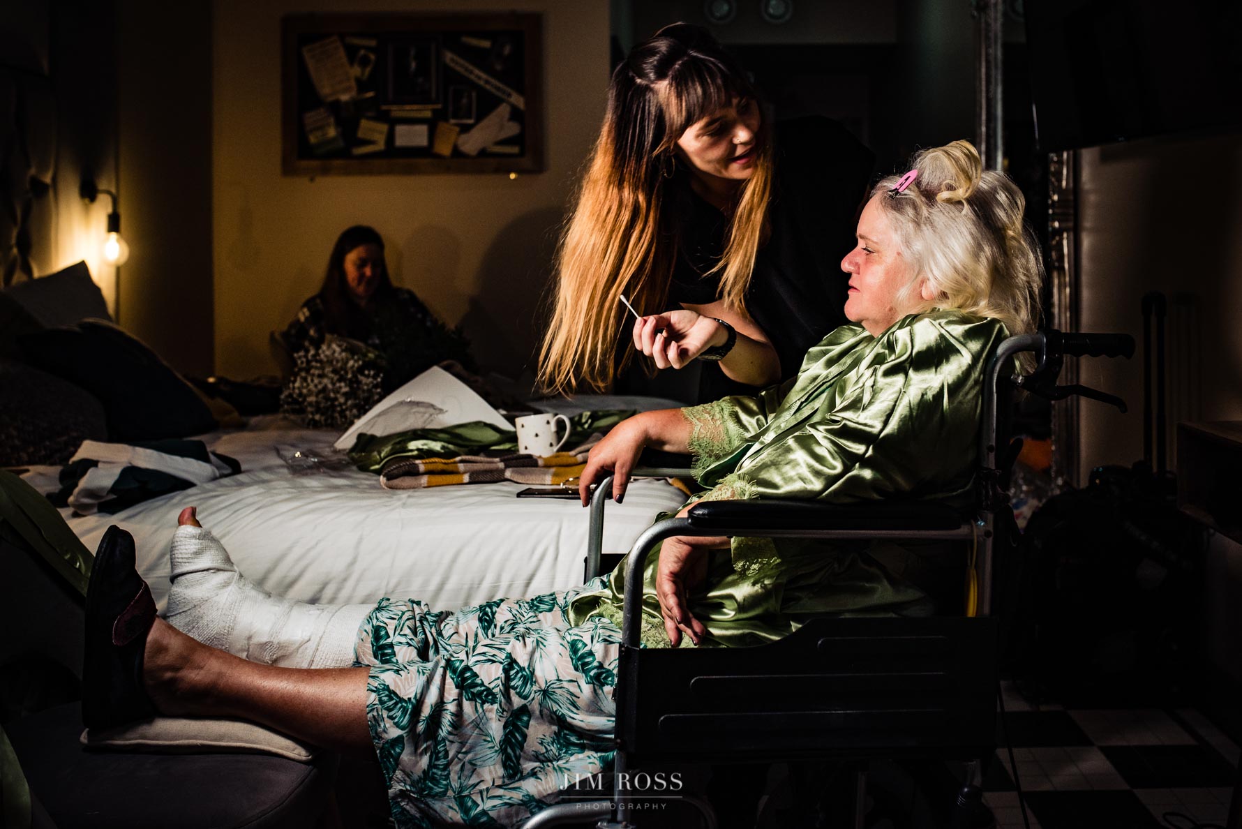 mother of bride getting makeup while nursing broken leg