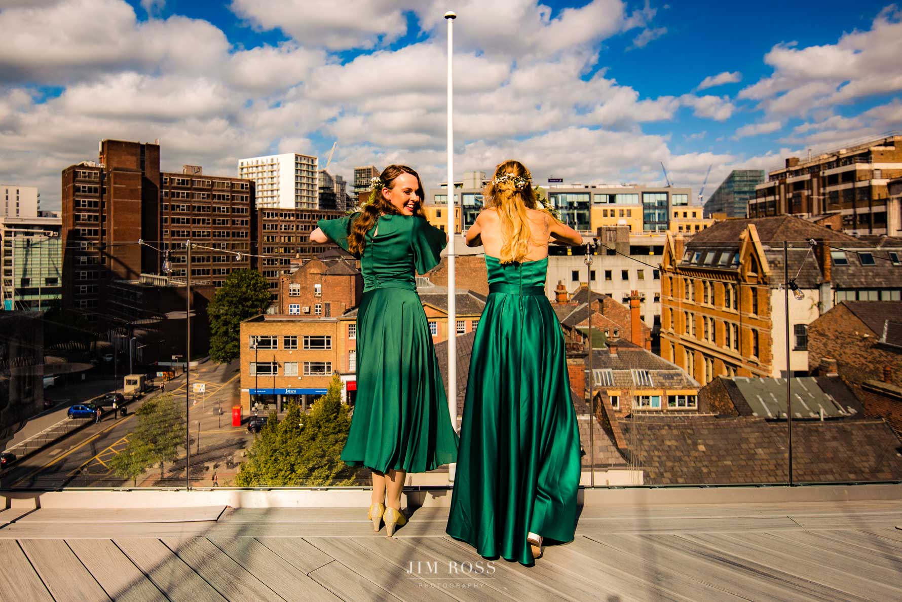 bridesmaids having a moment on the rooftop