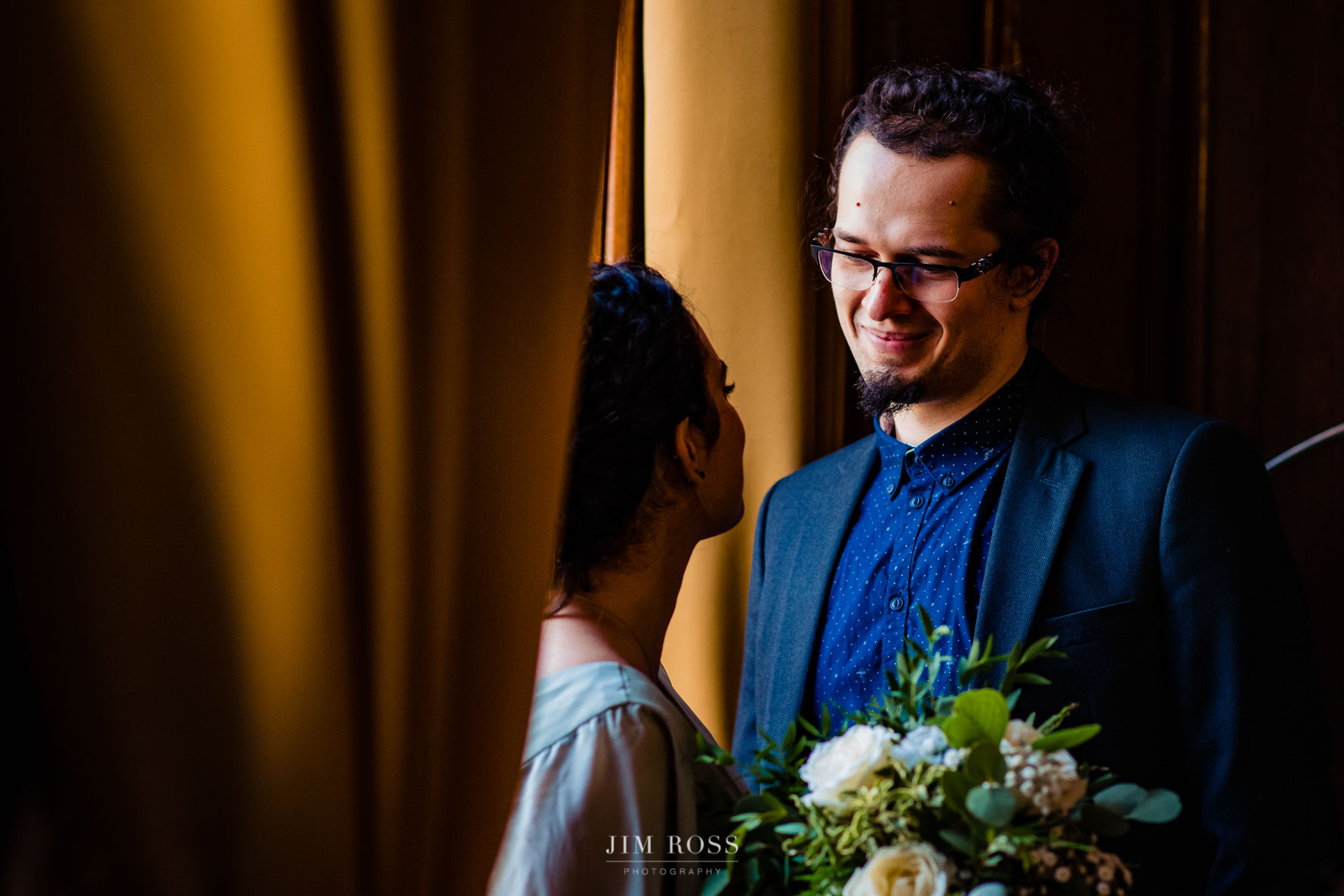 quiet moment in window light for wedding guests