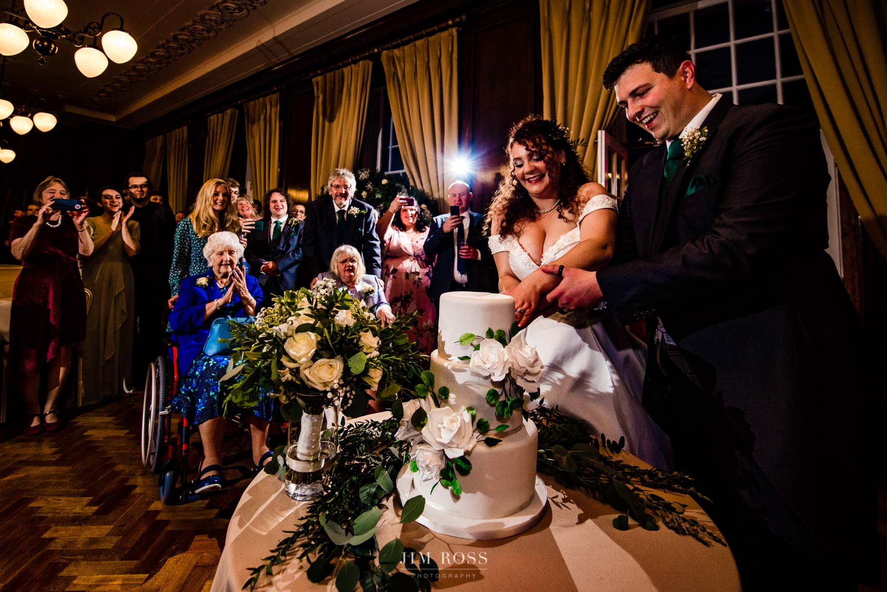 cake cut with guests behind