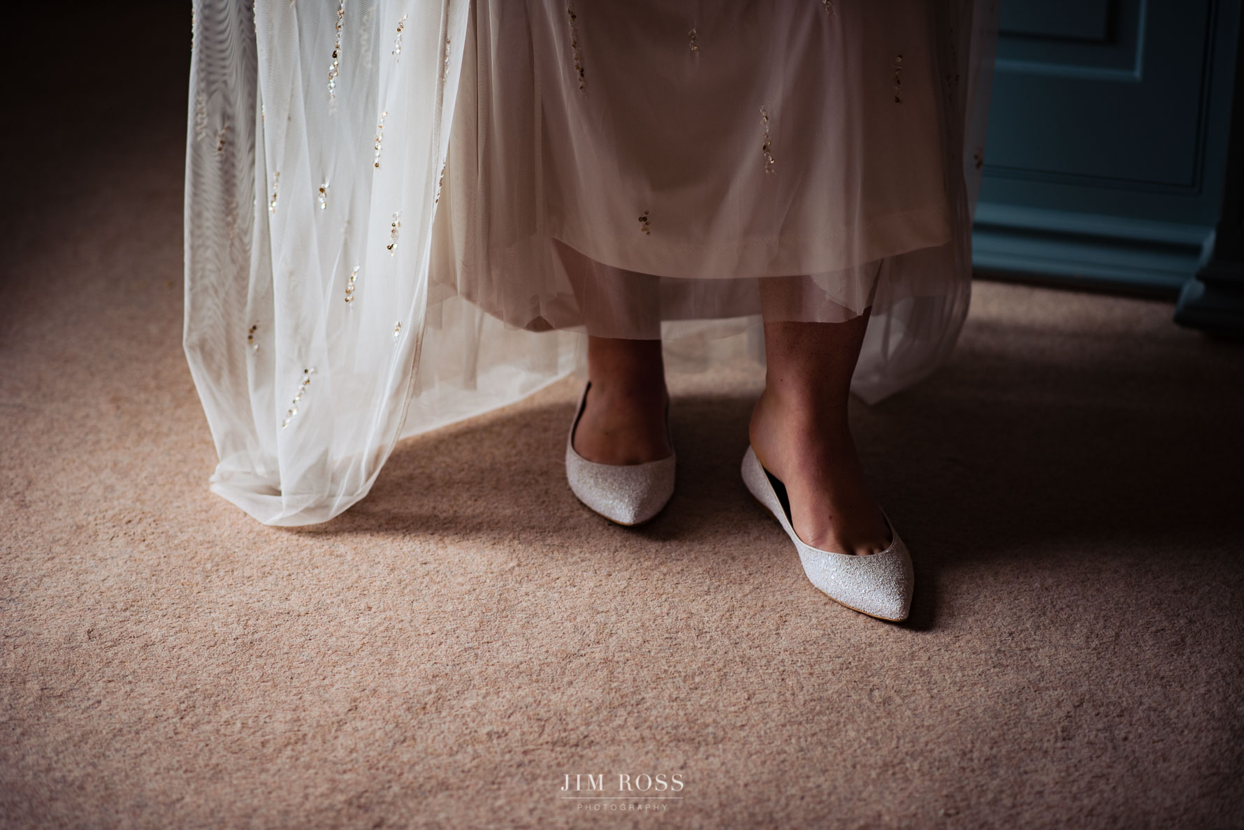 slipping foot into wedding shoes