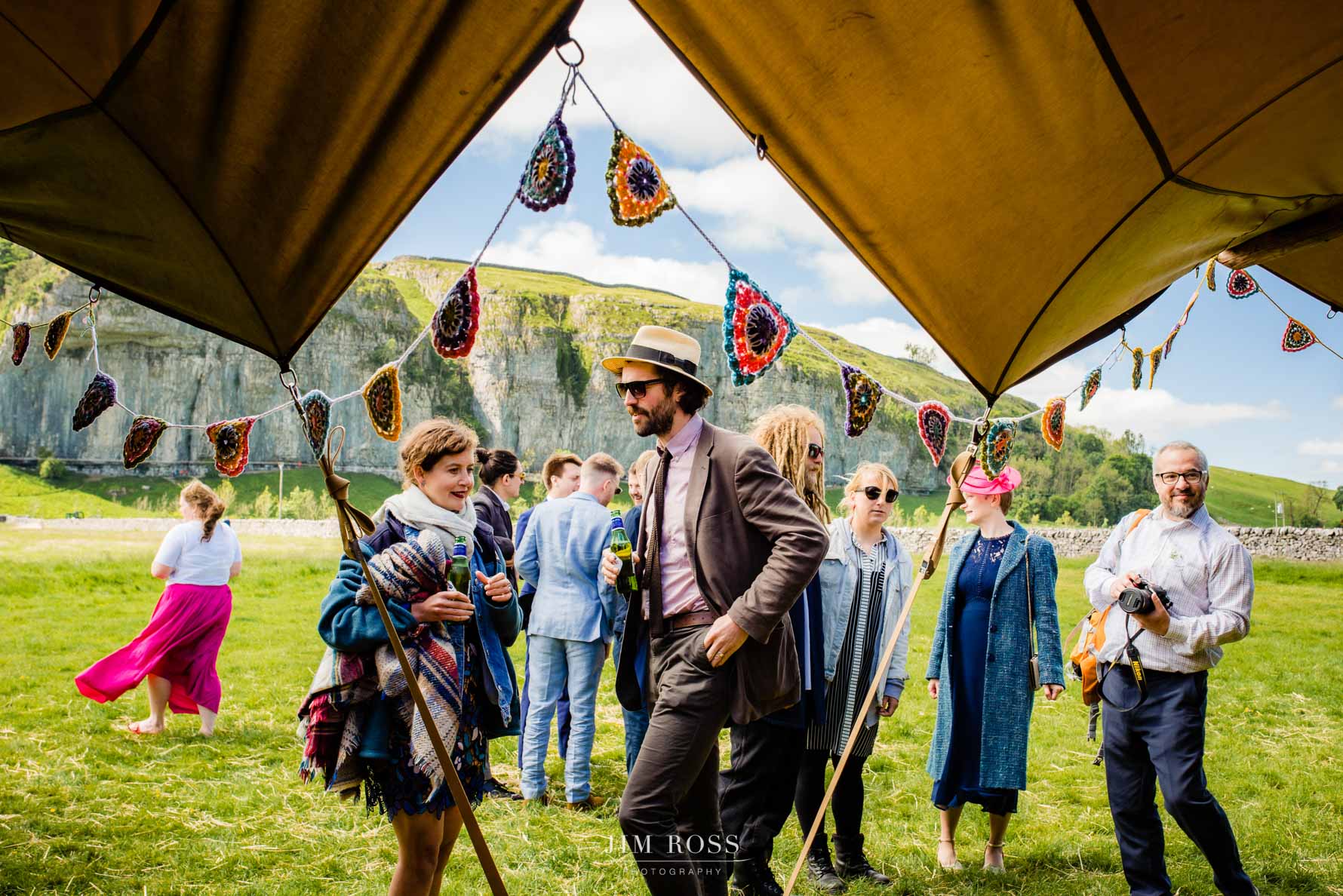 guests arrive at tipi wedding with yorkshire crags in background