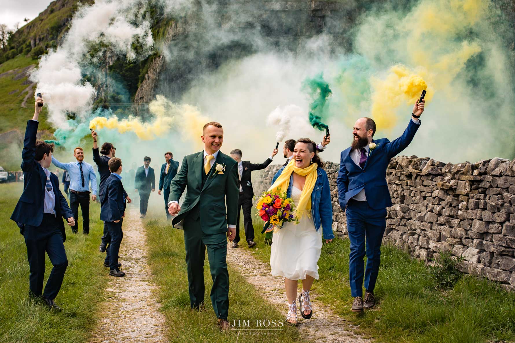 bridge and groom head wedding procession with smoke bombs in green and white