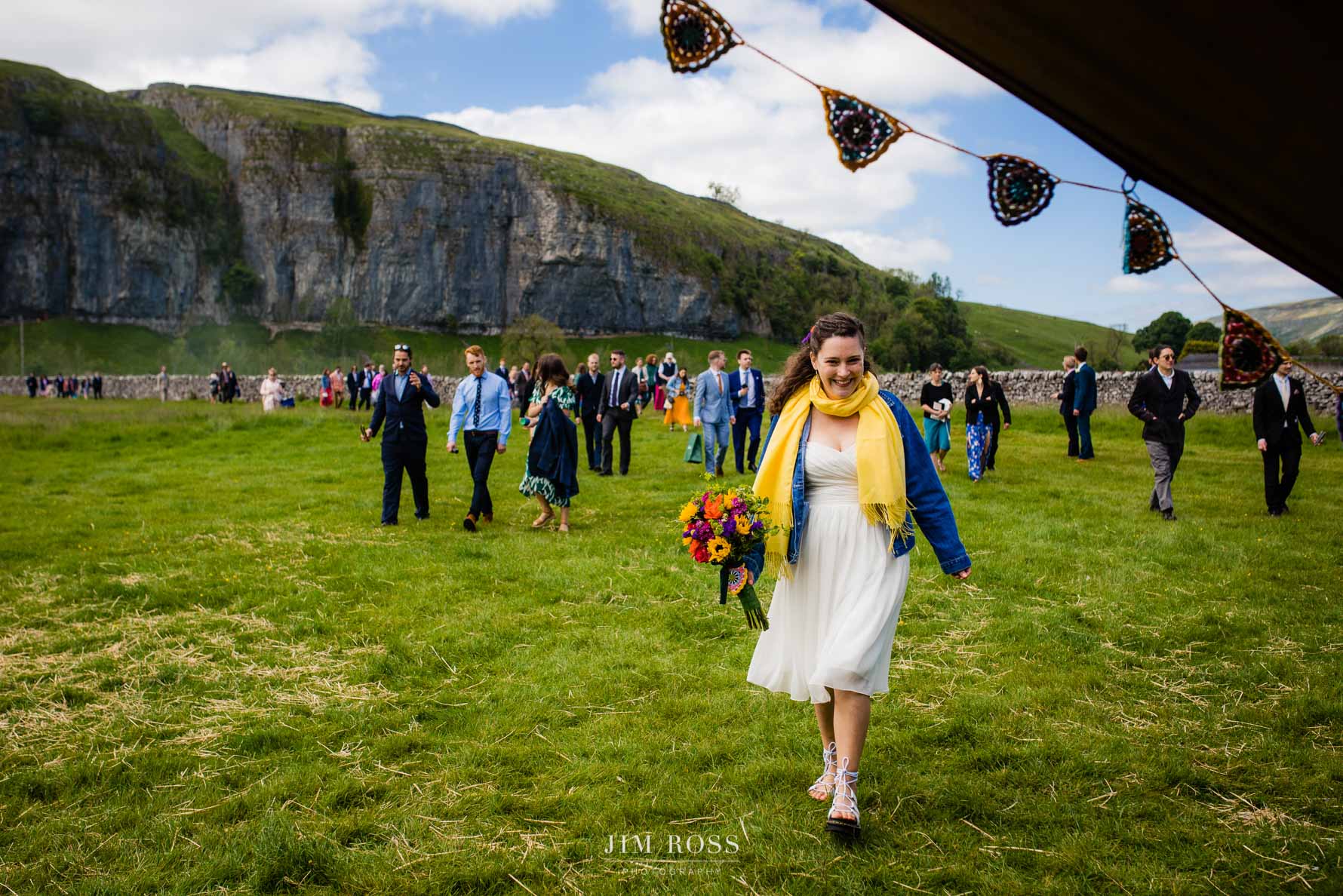 bride leads guests into tipi wedding reception