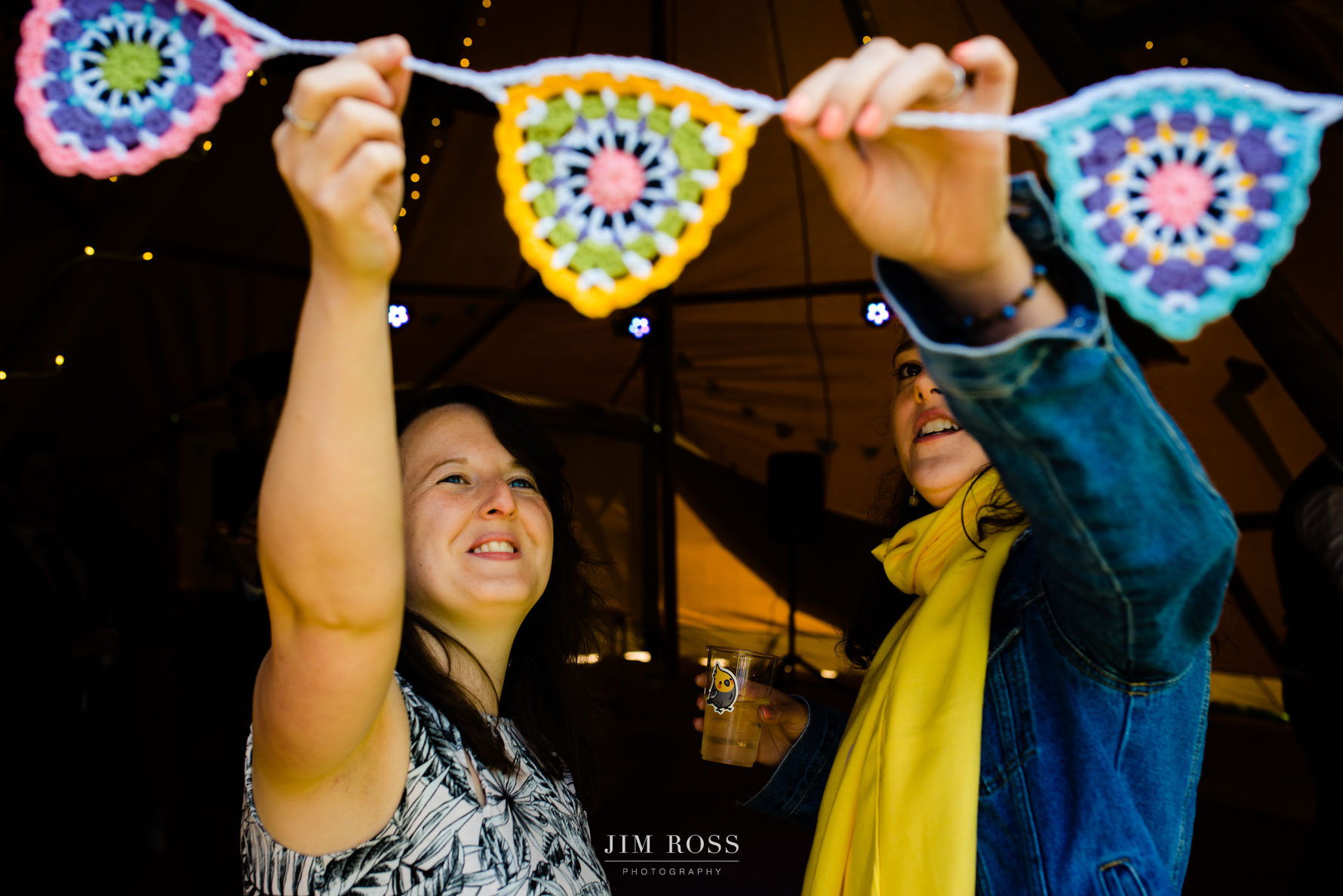 bride and friend admire homemade crocheted bunting