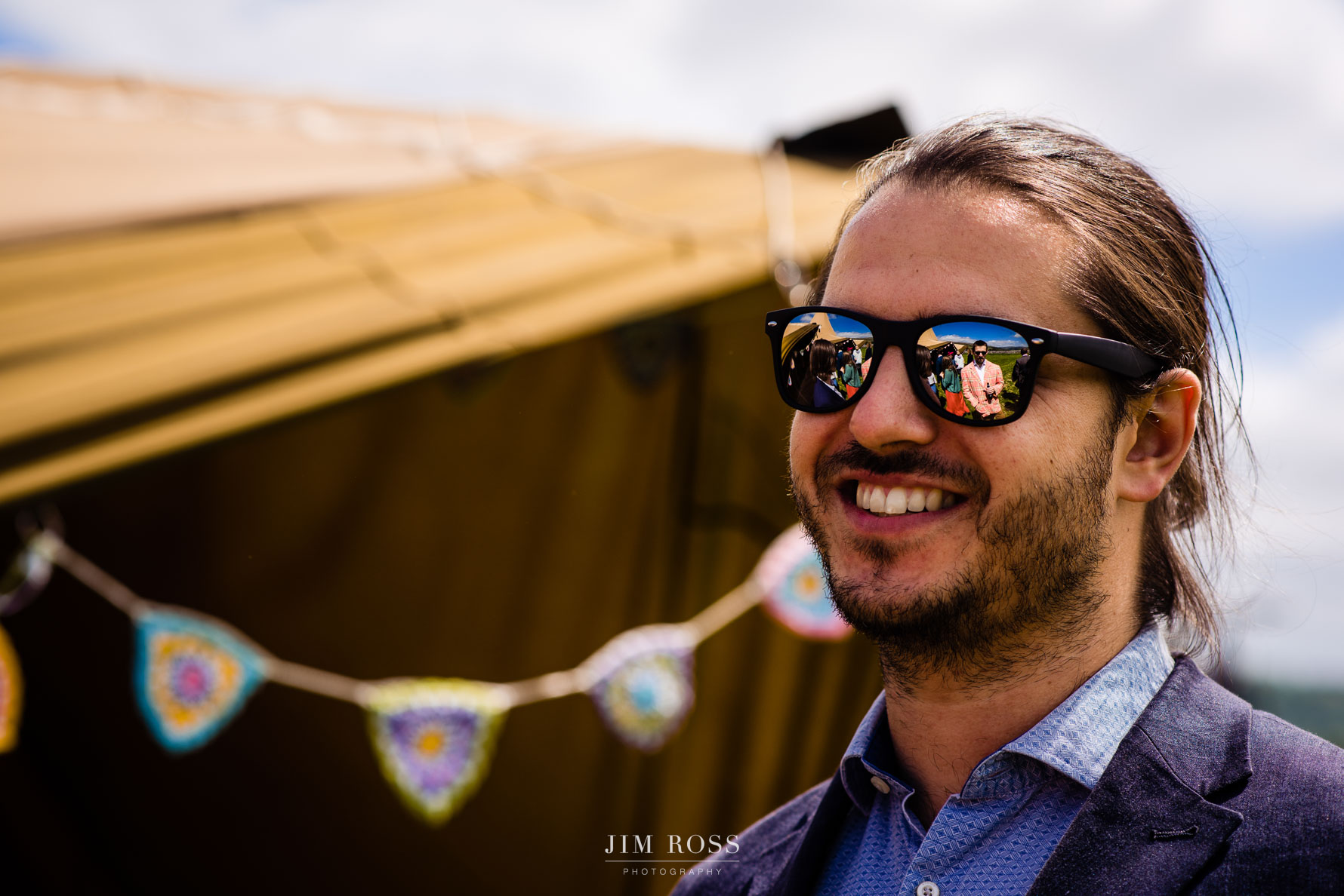 Reflection in sunglasses at tipi wedding