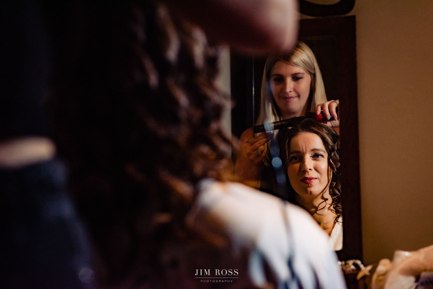 pretty shot of bride in mirror with final hair styling