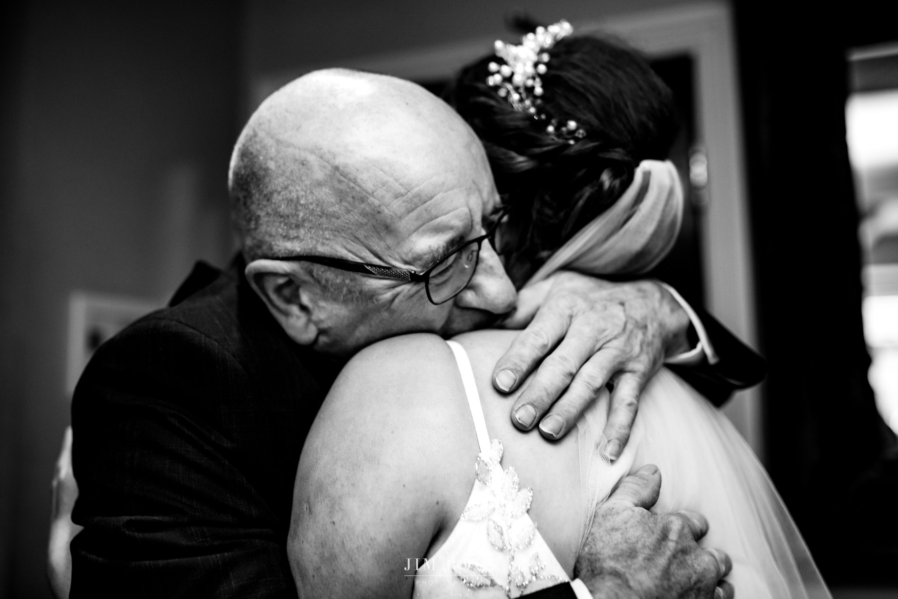 tight squeeze from Dad as he seems bride for first time