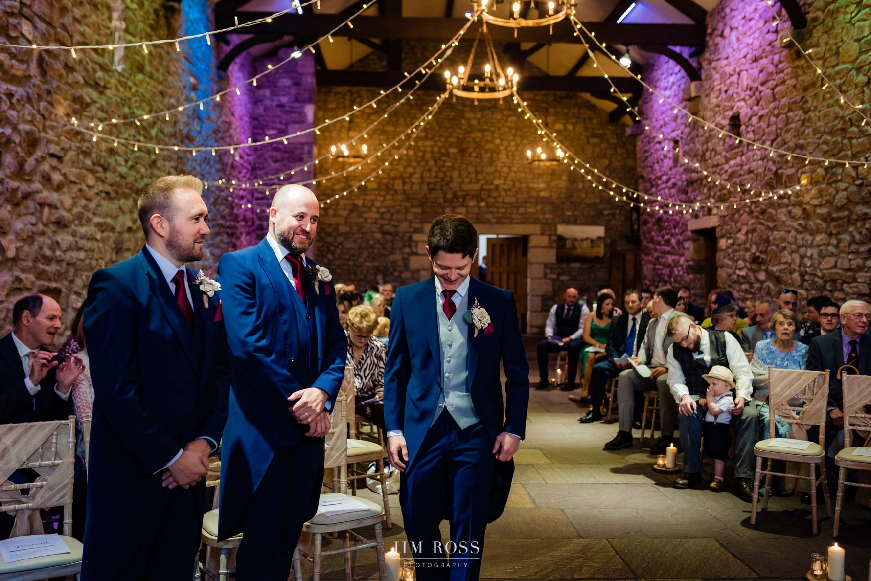 groomsmen in wedding barn