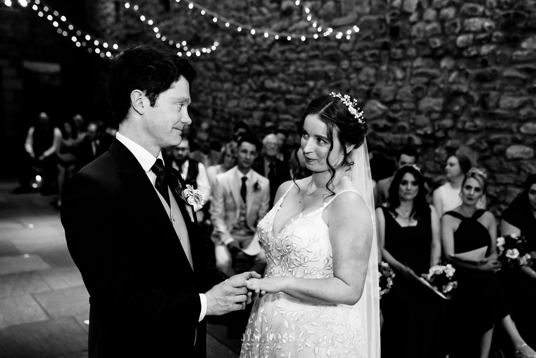 coy look from bride to groom during ring exchange