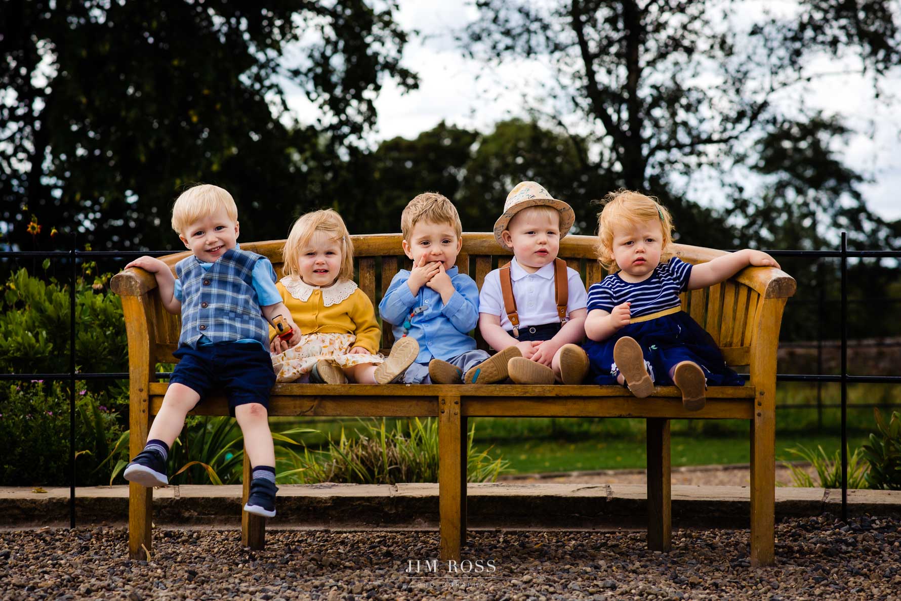 five related toddlers on a bench