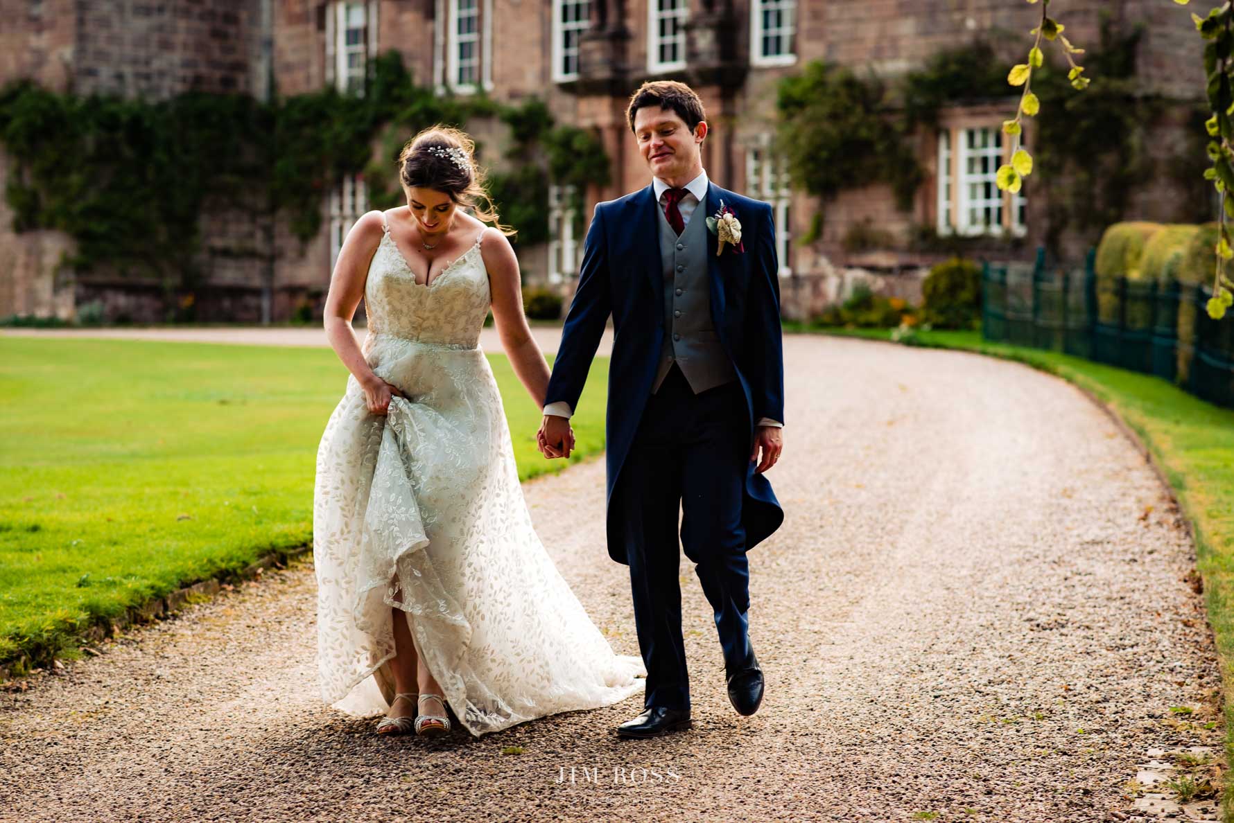 happy couple walking in front of Browsholme Hall