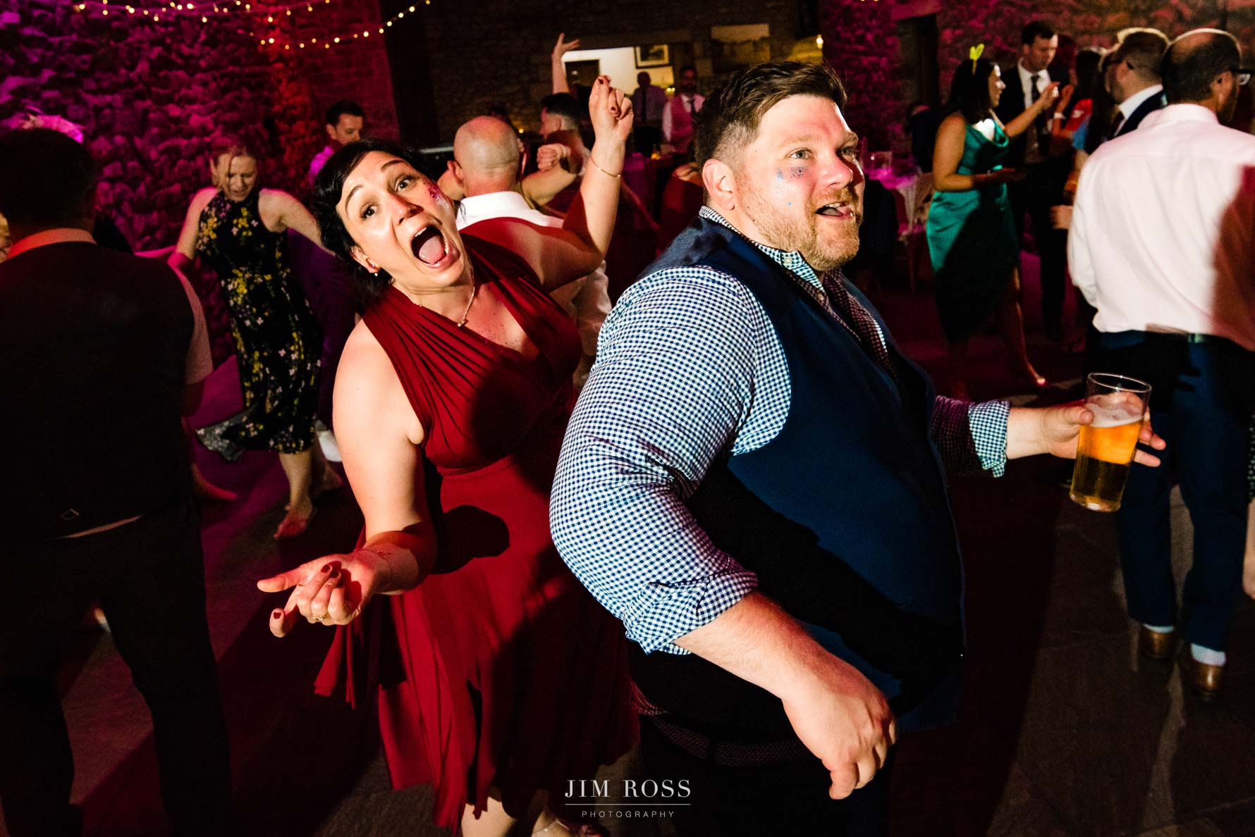 bridesmaid and husband dancing