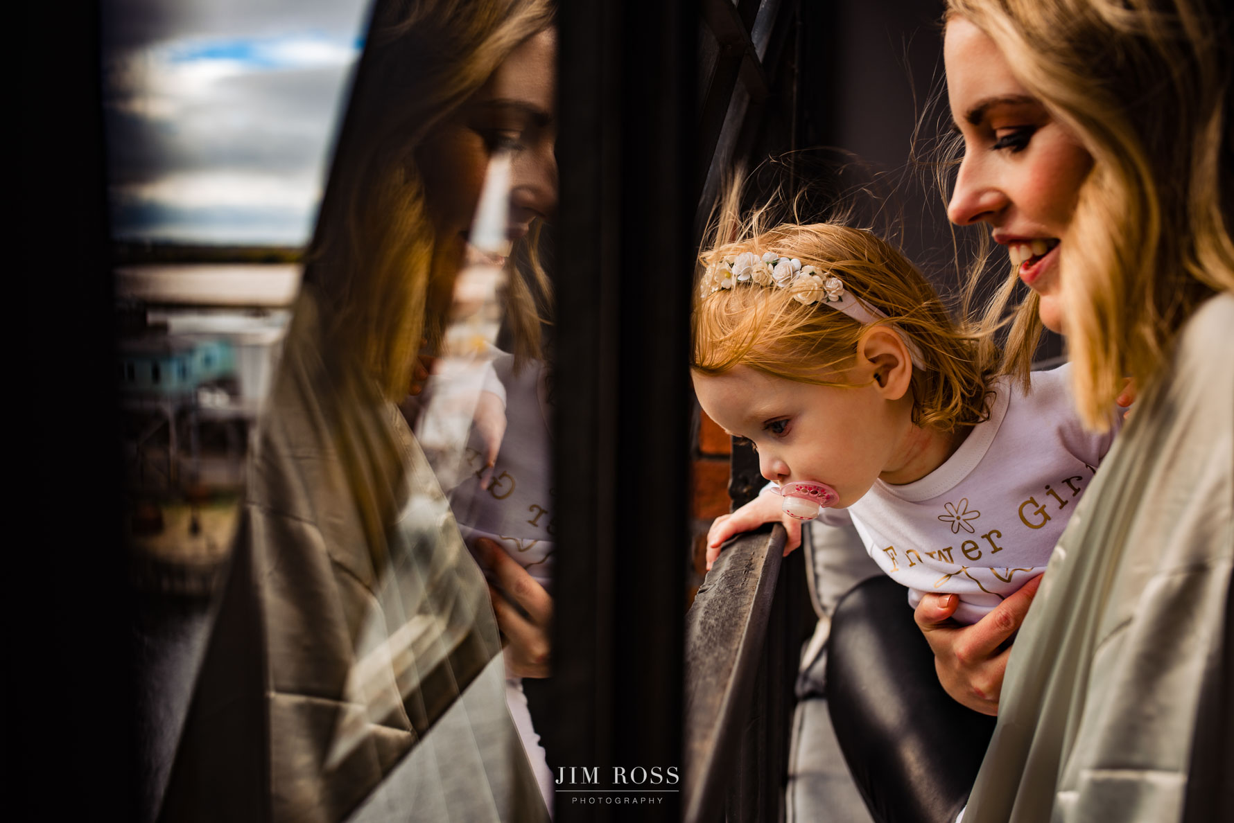bride's sister and child looking out of hotel window