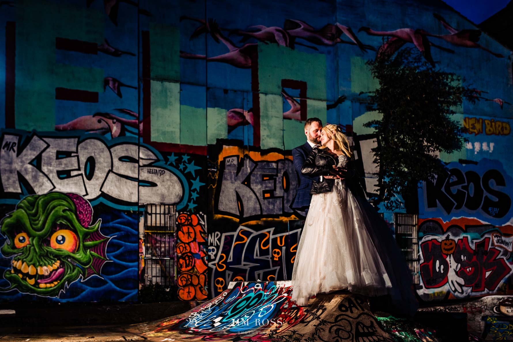 Spoons pose for flash-lit couple in graffiti skate park