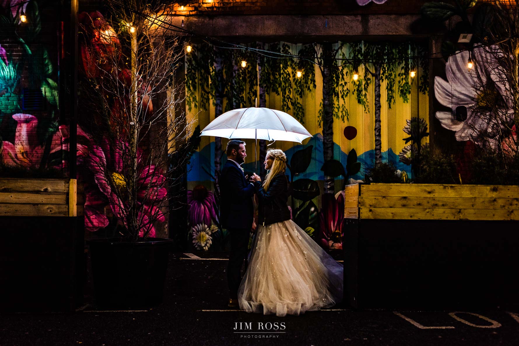 Colourful night portrait under umbrella