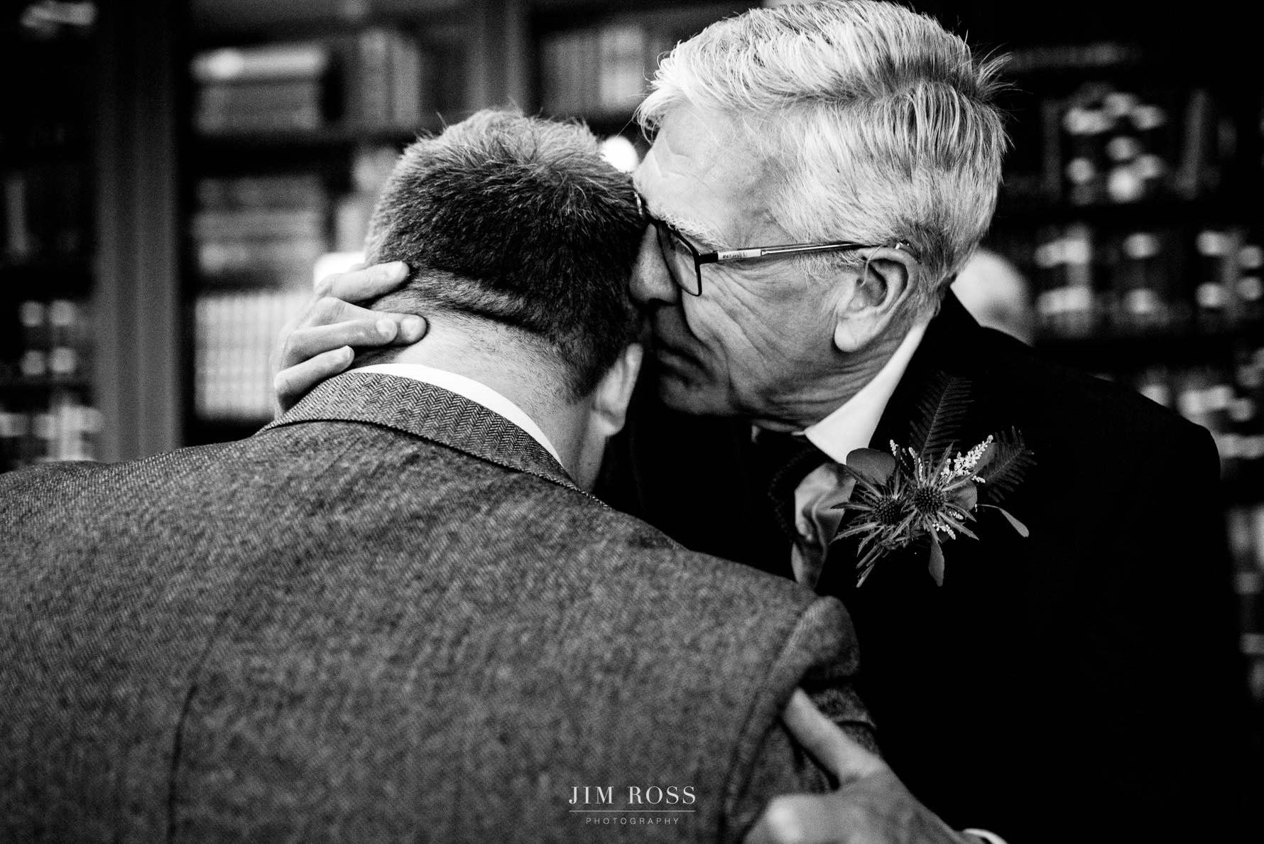 Bride's dad with a welcoming word in groom's ear